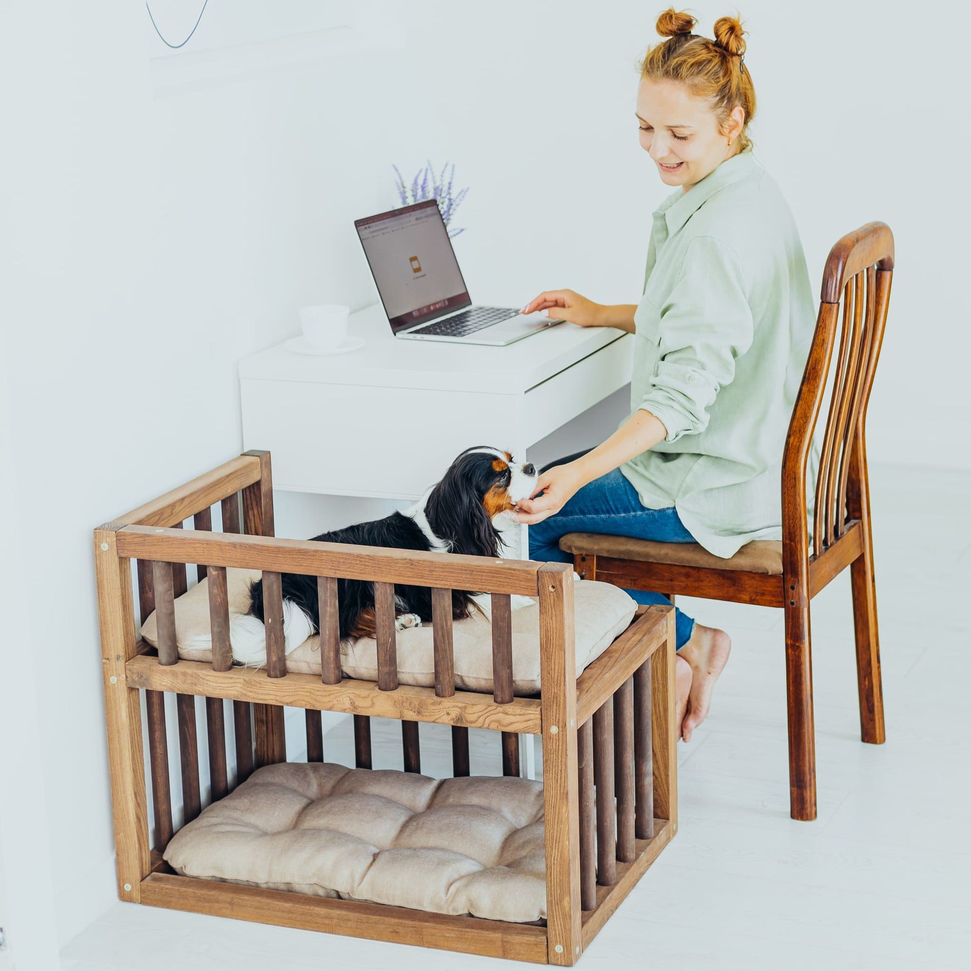 A minimalist dog bed platform positioned beside a work table, providing a cozy spot for your pet while you work